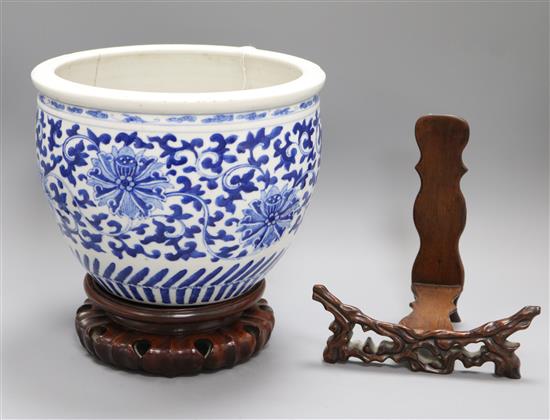 A Chinese blue and white jardiniere and two Chinese hardwood stands